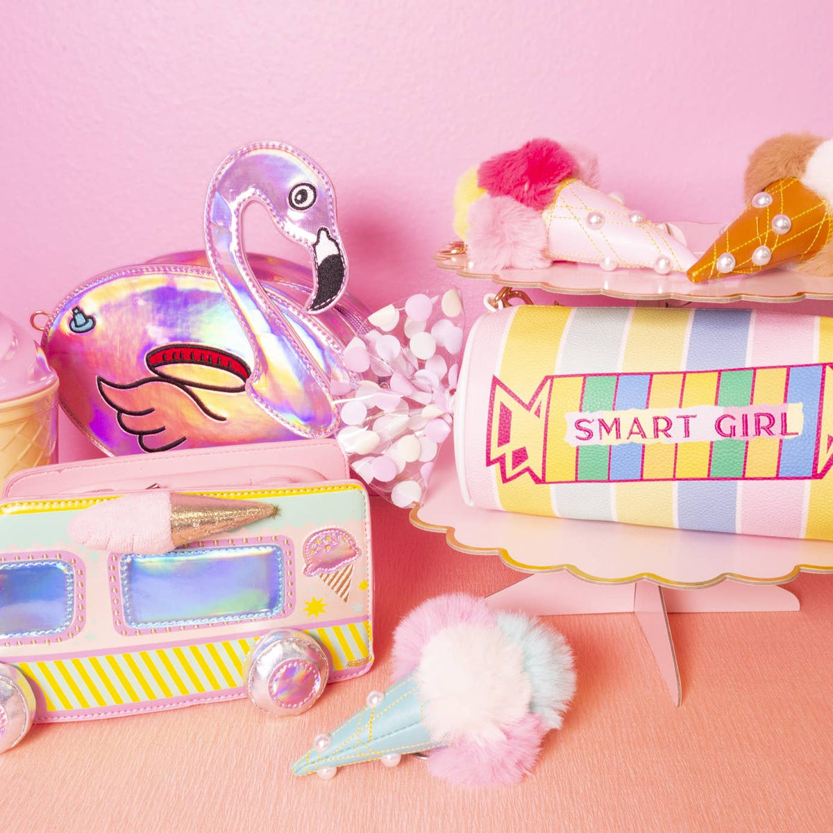 Colorful stationery items including a flamingo-shaped pouch, a pencil case, and a cup with 'SMART GIRL' text on a pink background.