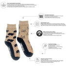 A pair of socks shown on a white background with callout lines and text explaining product features and sustainability claims. The socks have a dark navy heel and toe with black bear and tree patterns, and a tan/beige body with a subtle tree pattern.
