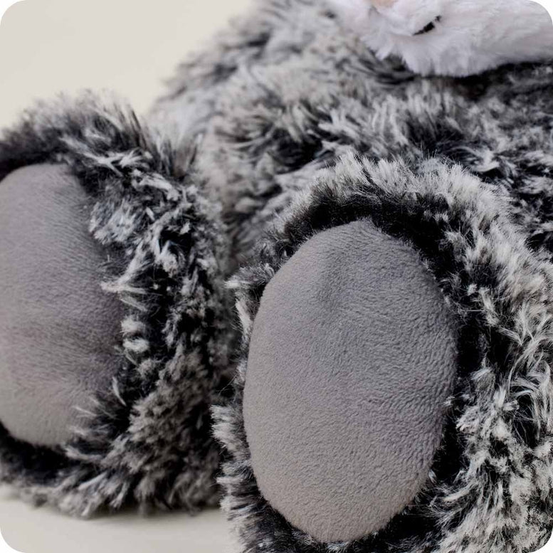 A close-up view of the Opossum by Warmies stuffed animal, highlighting its soft gray paws and fluffy black-and-gray textured fur.