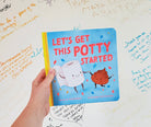 Book titled 'Let's Get This Potty Started' held by a hand on a white background with writing.