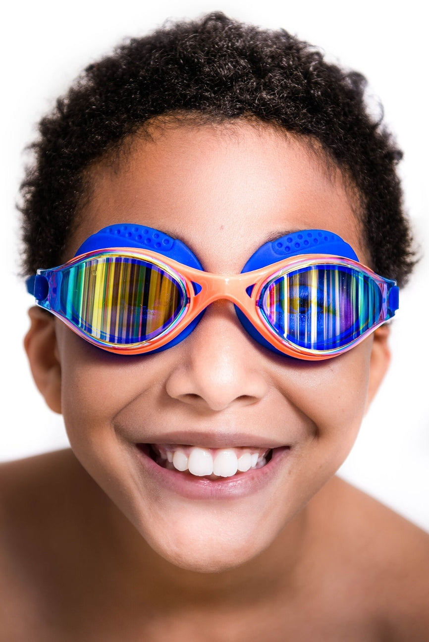 Child wearing colorful swim goggles on a white background