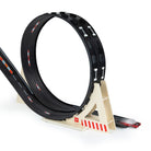 Black toy track with a white stand on a white background