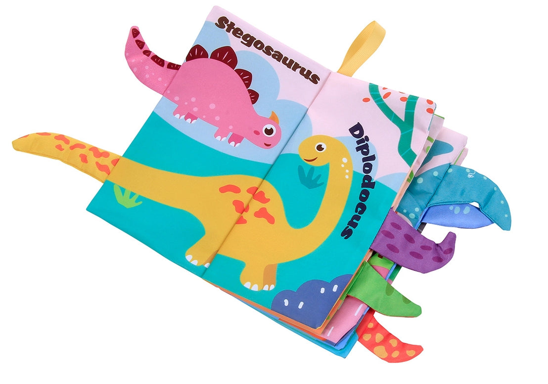 A colorful children's fabric book with dinosaur illustrations and pull tabs, photographed on a plain white background.