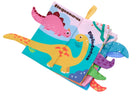 A colorful children's fabric book with dinosaur illustrations and pull tabs, photographed on a plain white background.