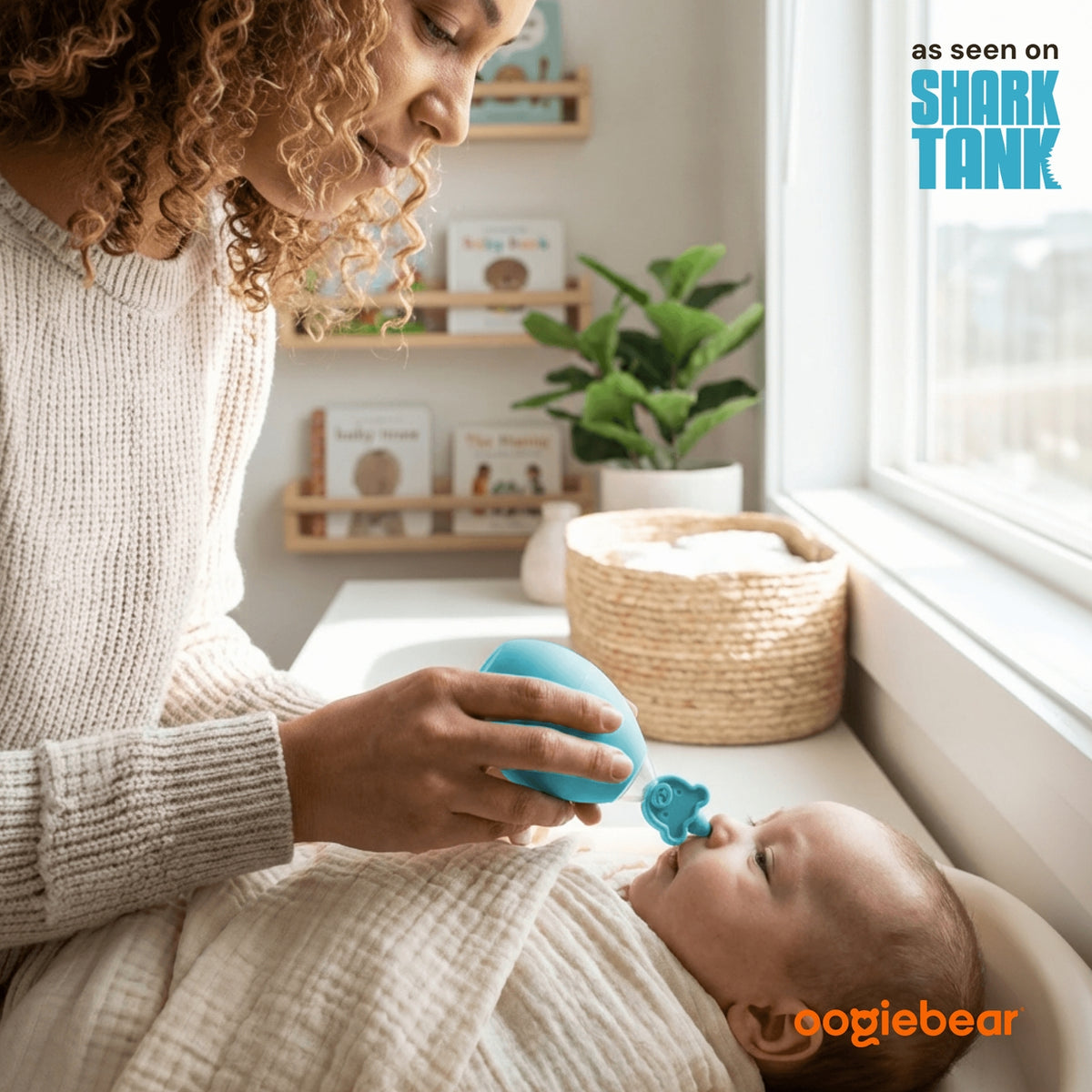 Woman holding a blue teething ball to a baby's mouth in a home setting, with 'Shark Tank' branding.
