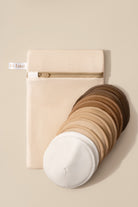Set of round cushions in various colors with a textured beige pouch on a beige background