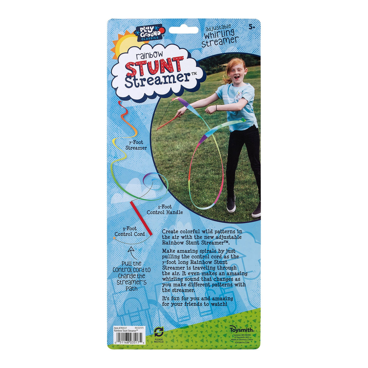 Packaging of a rainbow stunt streamer toy with a child using it on a grassy field.