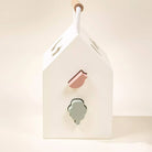 House-shaped light fixture with a pink and green design on a white background