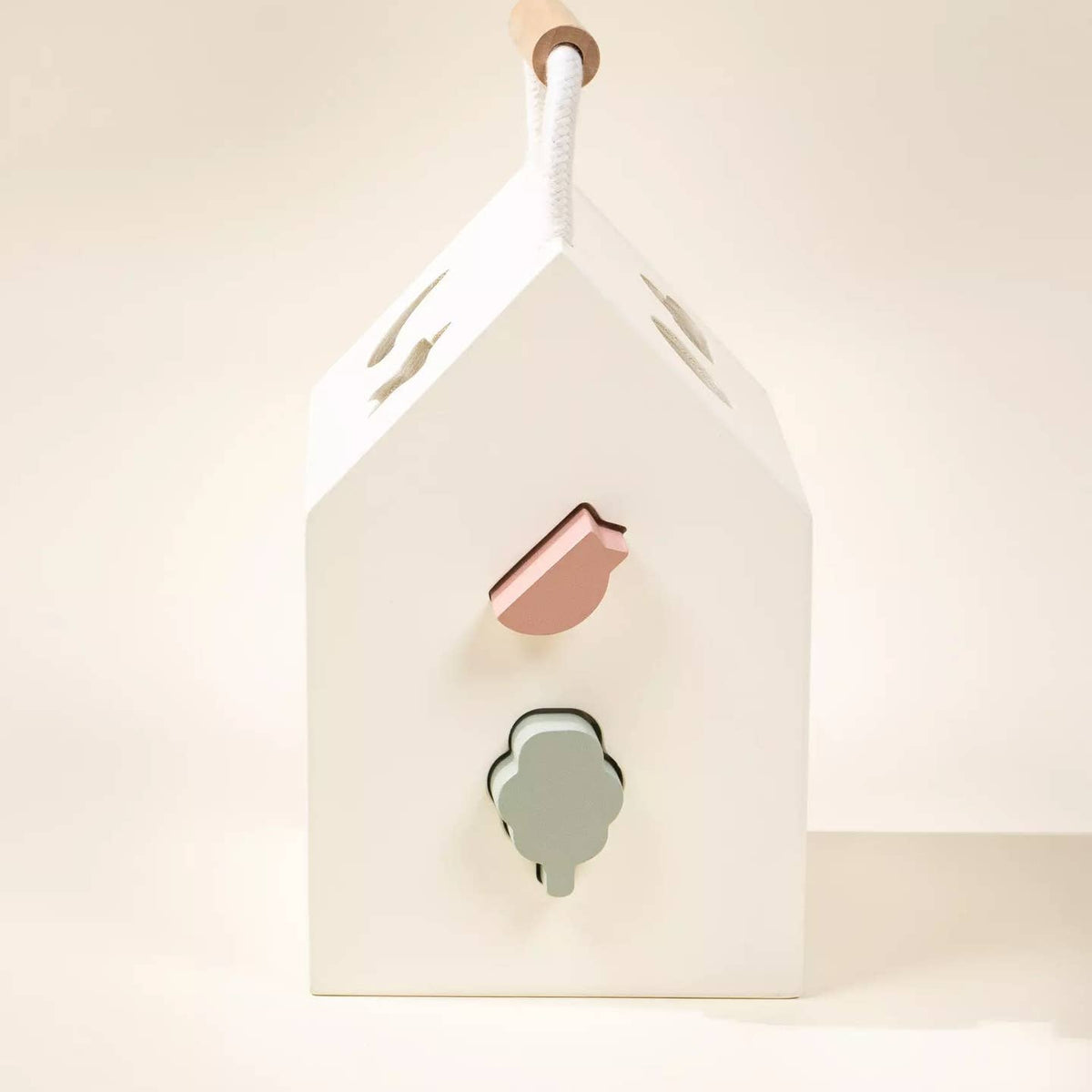 House-shaped light fixture with a pink and green design on a white background