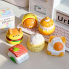 Set of cute food-themed desk organizers on a desk with a keyboard in the background.