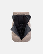 Beige pet coat with black interior on a white background