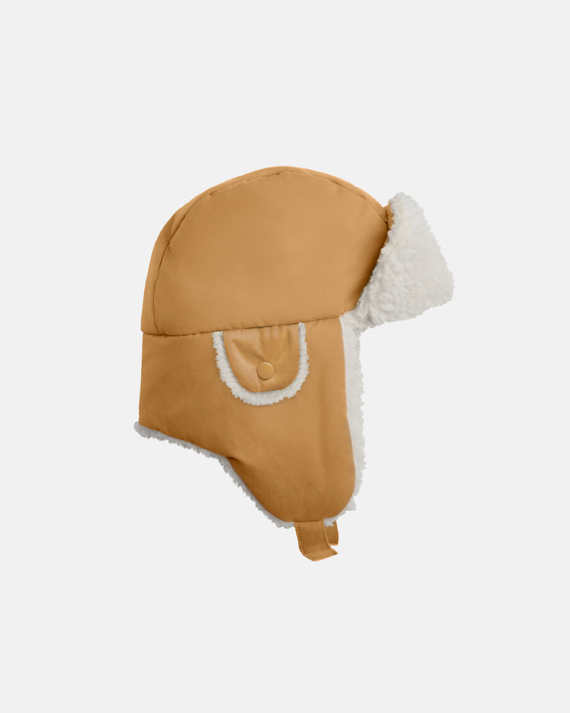 The Benji Sherpa Chapka Hat by 7AM Enfant in cognac, shown from the side against a white background.