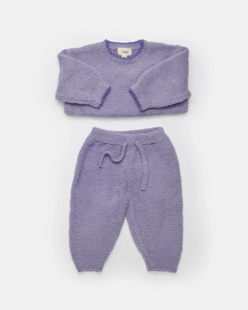A complete taro purple fuzzy winter set arranged flat against a white background, featuring a boxy sweater and lounge pants with a matching drawstring.