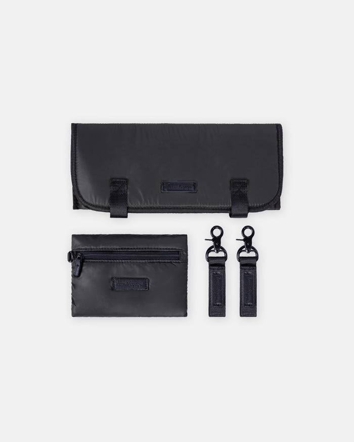 Black travel accessory set with a pouch, wallet, and key holder on a white background