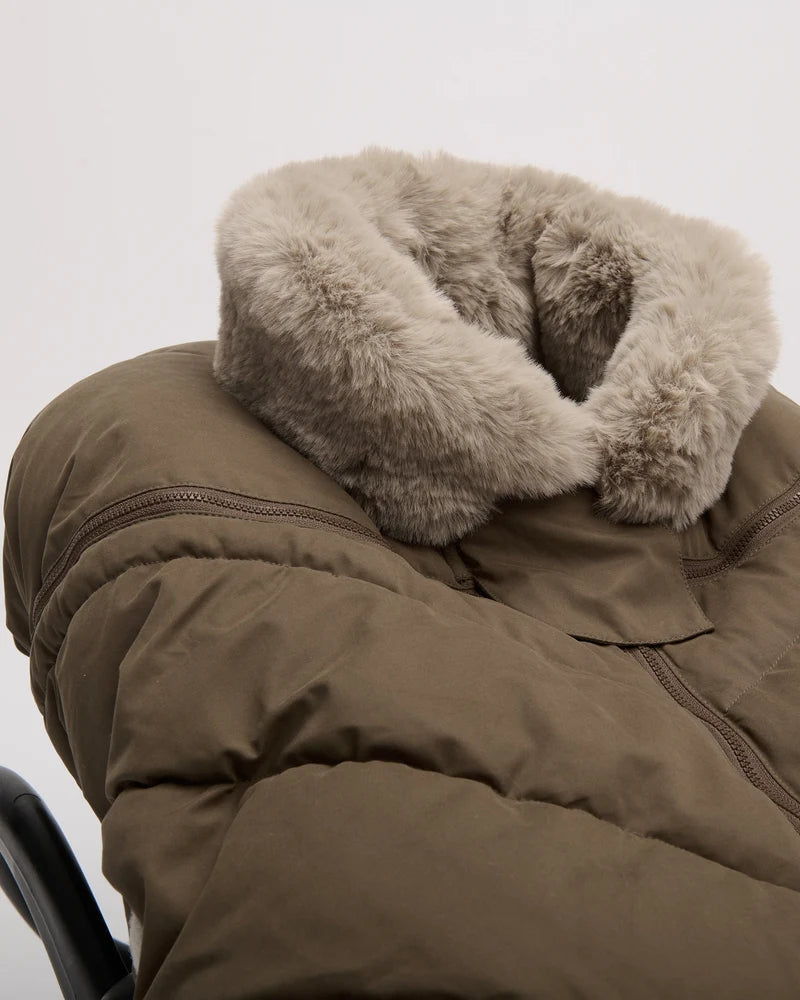 Close-up of the moss brown Helsinki Car Seat Cocoon by 7AM Enfant highlighting the plush faux-fur collar and quilted texture.