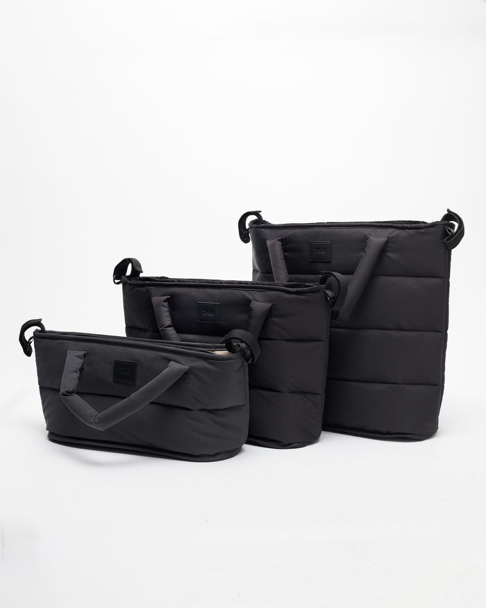 Set of black bags of different sizes on a white background