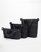 Set of black bags of different sizes on a white background