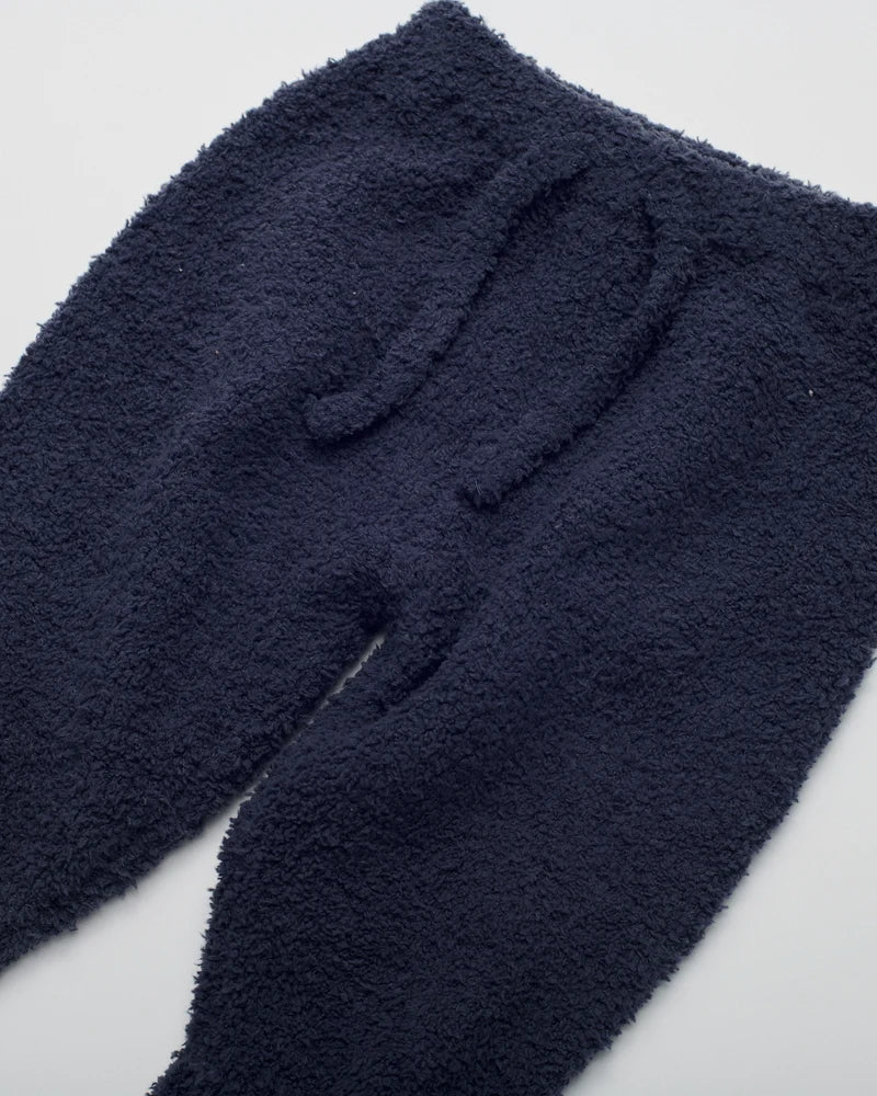 Navy blue fuzzy fleece pants with an elastic waistband and drawstring, shown against a plain white background.