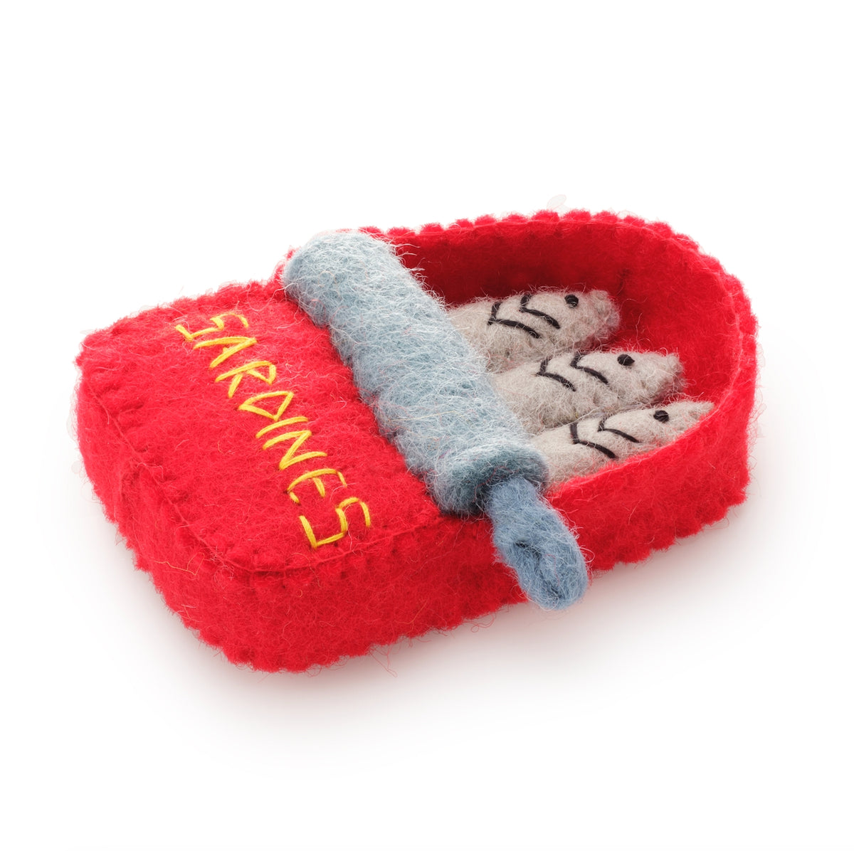 A red sardine tin with three gray felted sardines inside, a gray rolled pin, and yellow embroidered text reading 'SARDINES' 