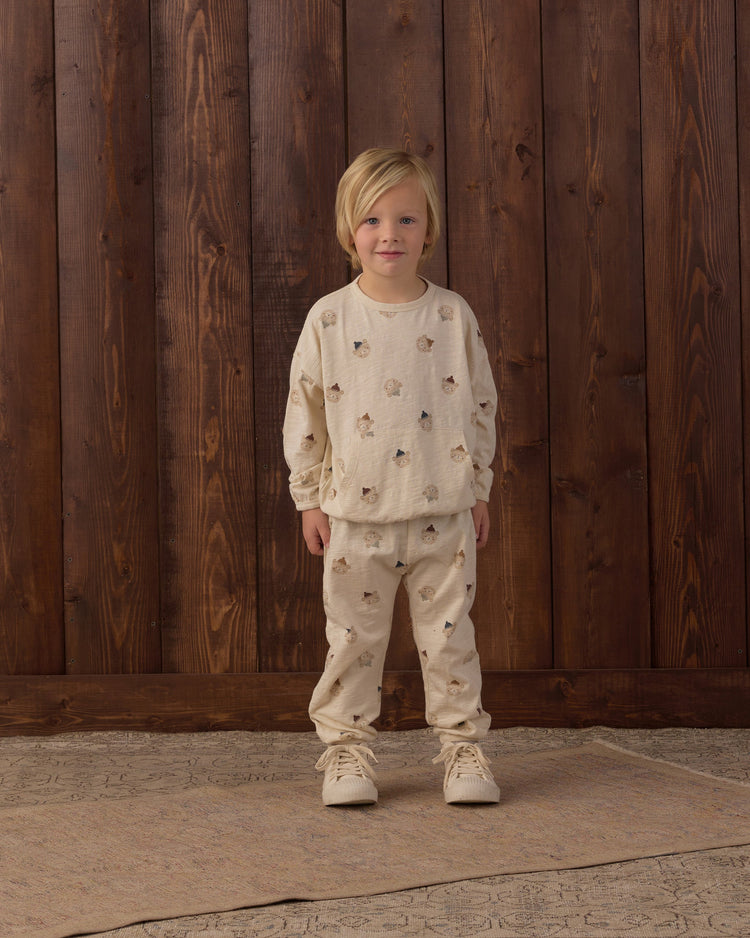 A child wearing the Rylee + Cru Winter Bears matching long-sleeve sweatshirt and pant set featuring an all-over patterned bear print.