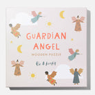 The Guardian Angel Wooden Puzzle by Be A Heart box features an off-white background with the text "GUARDIAN ANGEL WOODEN PUZZLE" in orange and brown, surrounded by playful illustrations of angels, suns, moons, and stars, with the brand logo "Be A Heart" centered at the bottom.