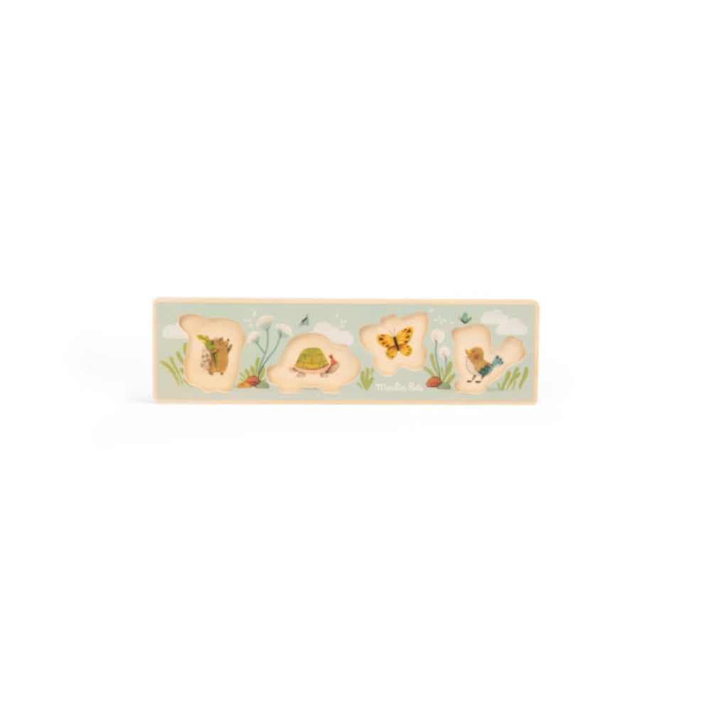 Decorative wooden panel with floral designs on a light blue background