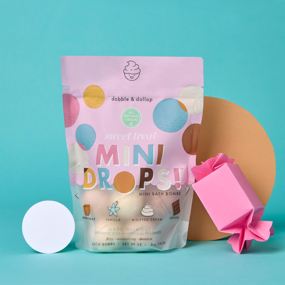 Dobble & Dallop mini bath bomb packaging with a pink bomb on a teal background