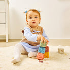 Child playing with colorful blocks on a carpeted floor