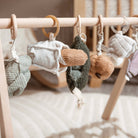 Baby mobile with hanging toys on a wooden crib