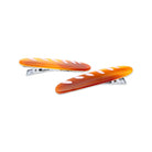 Two orange hair clips with white hearts on a white background