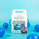 Sensory play jar packaging with blue balls on a teal background