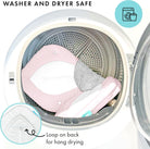 Washing machine with pink and gray items inside, labeled 'washer and dryer safe'.