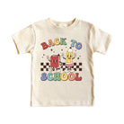 A cream-colored short-sleeve baby t-shirt featuring a colorful 'Back to School' graphic with cartoon book and pencil characters on a checkered background.
