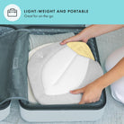 Person packing a travel pillow into a suitcase with text 'Lightweight and Portable' on a teal background.