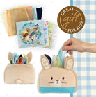 Children's book with a bunny design and a plush bunny bag on a checkered background.