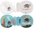 Children's book with ocean-themed illustrations and a brush on a white background