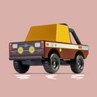 Toy truck with a yellow bed and brown body on a pink background