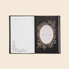 Open book with decorative cover and page on a beige background
