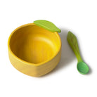 Yellow bowl and green spoon shaped like a lemon on a white background