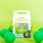 Green sensory play jar packaging with green balls on a green background