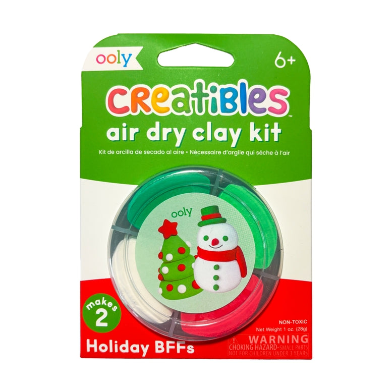 Ooly Creatibles Holiday BFFs air dry clay kit in retail blister packaging, featuring green, white, and red clay rolls with a snowman and Christmas tree illustration on the front.