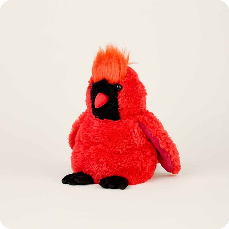 A full-body view of the Red Cardinal by Warmies plush toy, showcasing its bright red fuzzy fur, textured crest, black face with a red beak, and soft black feet standing against a neutral background.