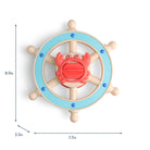 Wooden toy steering wheel with a crab figure on a white background