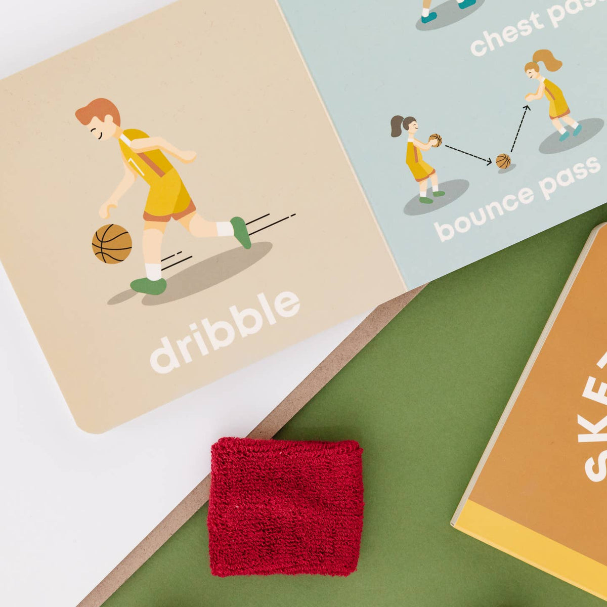 Red sweatband on a green surface with educational cards about basketball moves.
