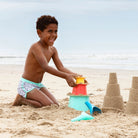 Child playing with sand toys on a beach