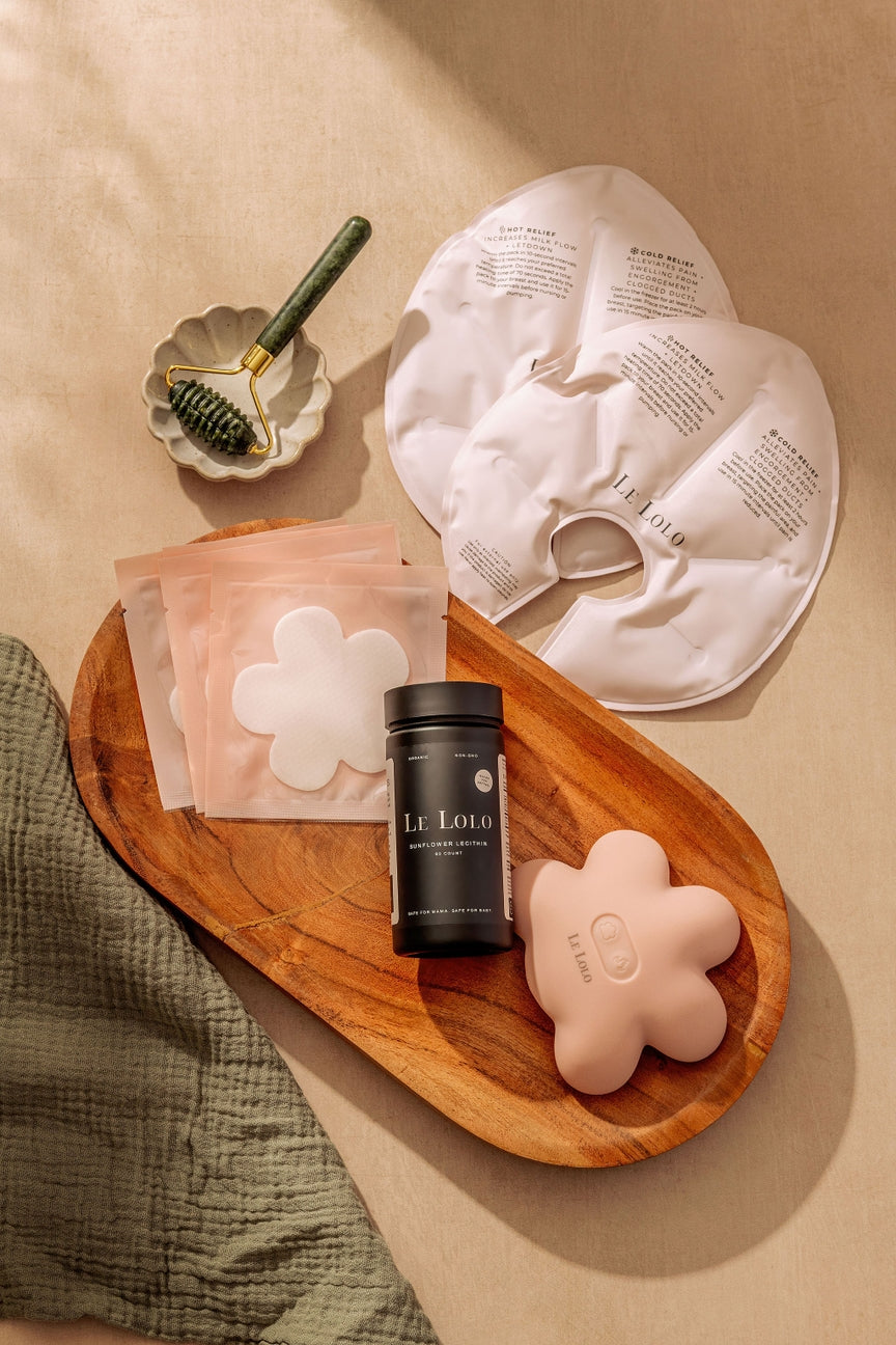 Skincare products including face masks and a jar on a wooden tray with a neutral background