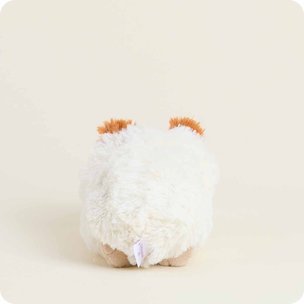 White plush toy with brown accents on a beige background