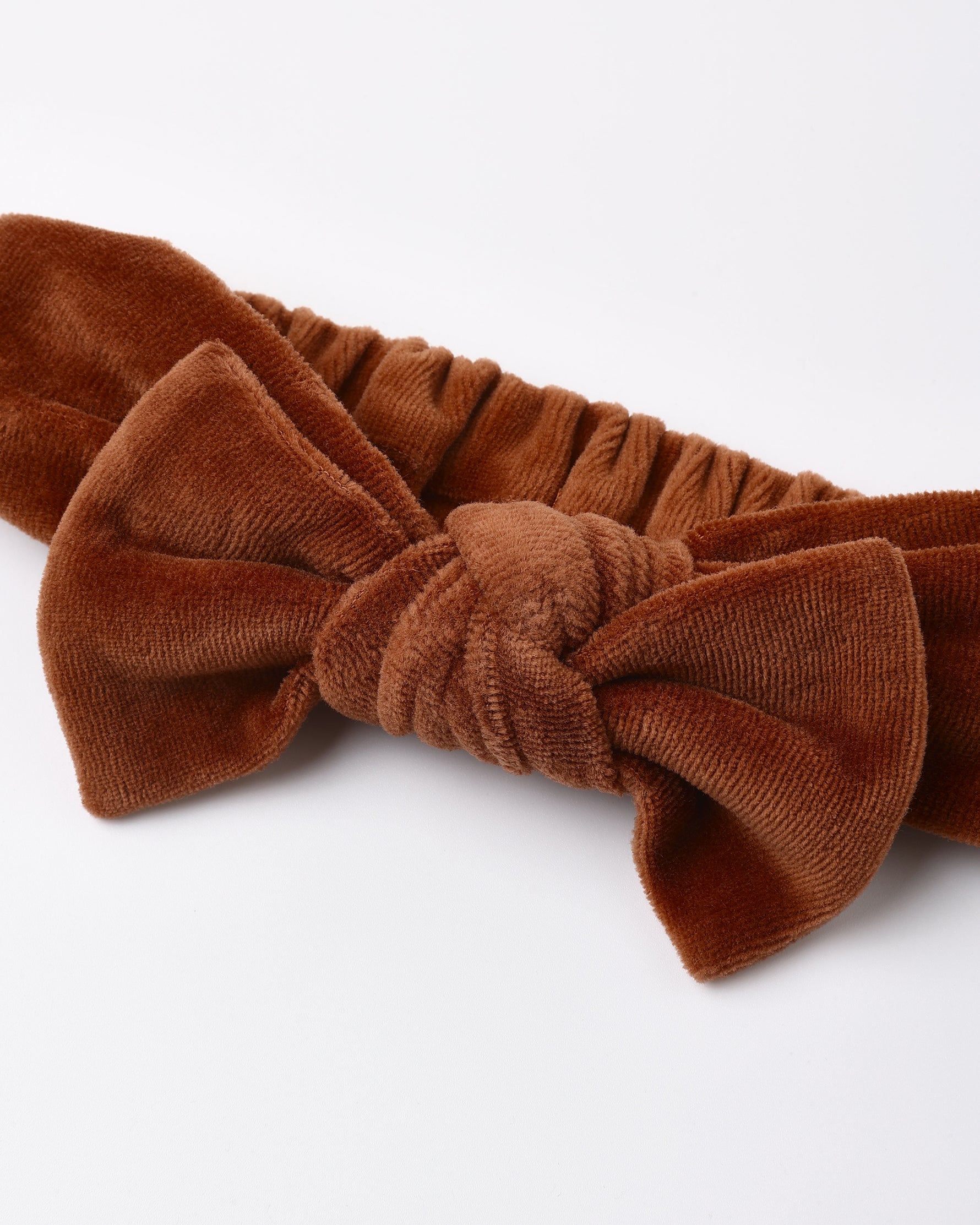 Velour bow headband in redwood by Quincy Mae featuring a plush, textured fabric with an oversized bow and elastic back on a white background.