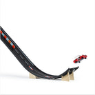 Toy car on a black track with red and blue accents on a white background