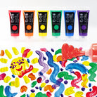 Set of colorful JR washable paint tubes with paint splashes on a white background